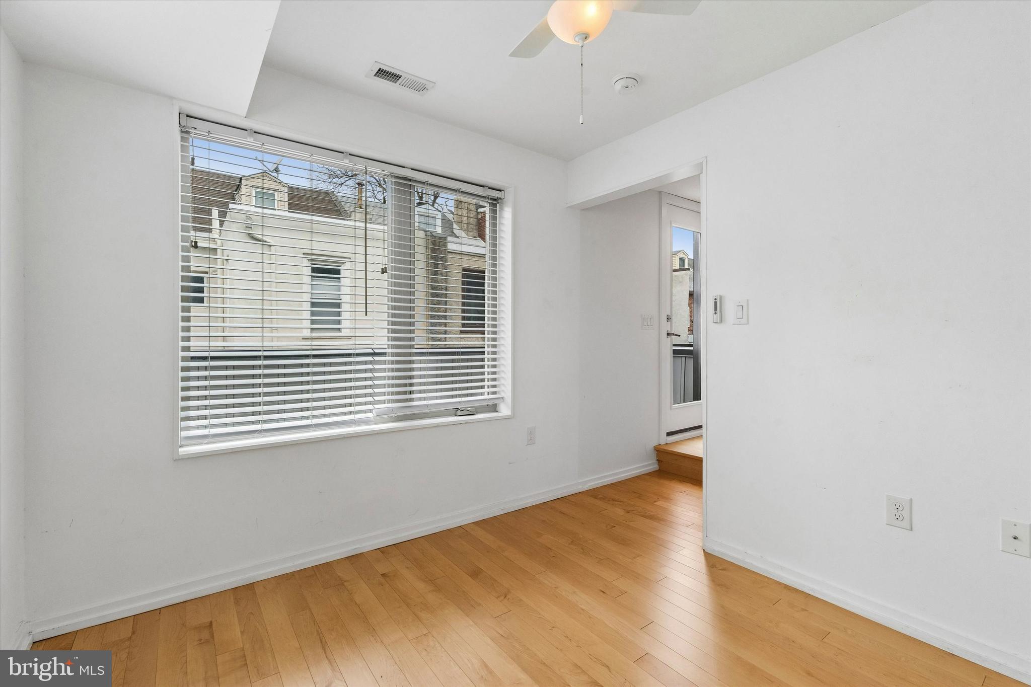 936 North Leithgow Street Philadelphia, PA 19123 - Photo 15 of 40 a view of an empty room with a window and wooden floor