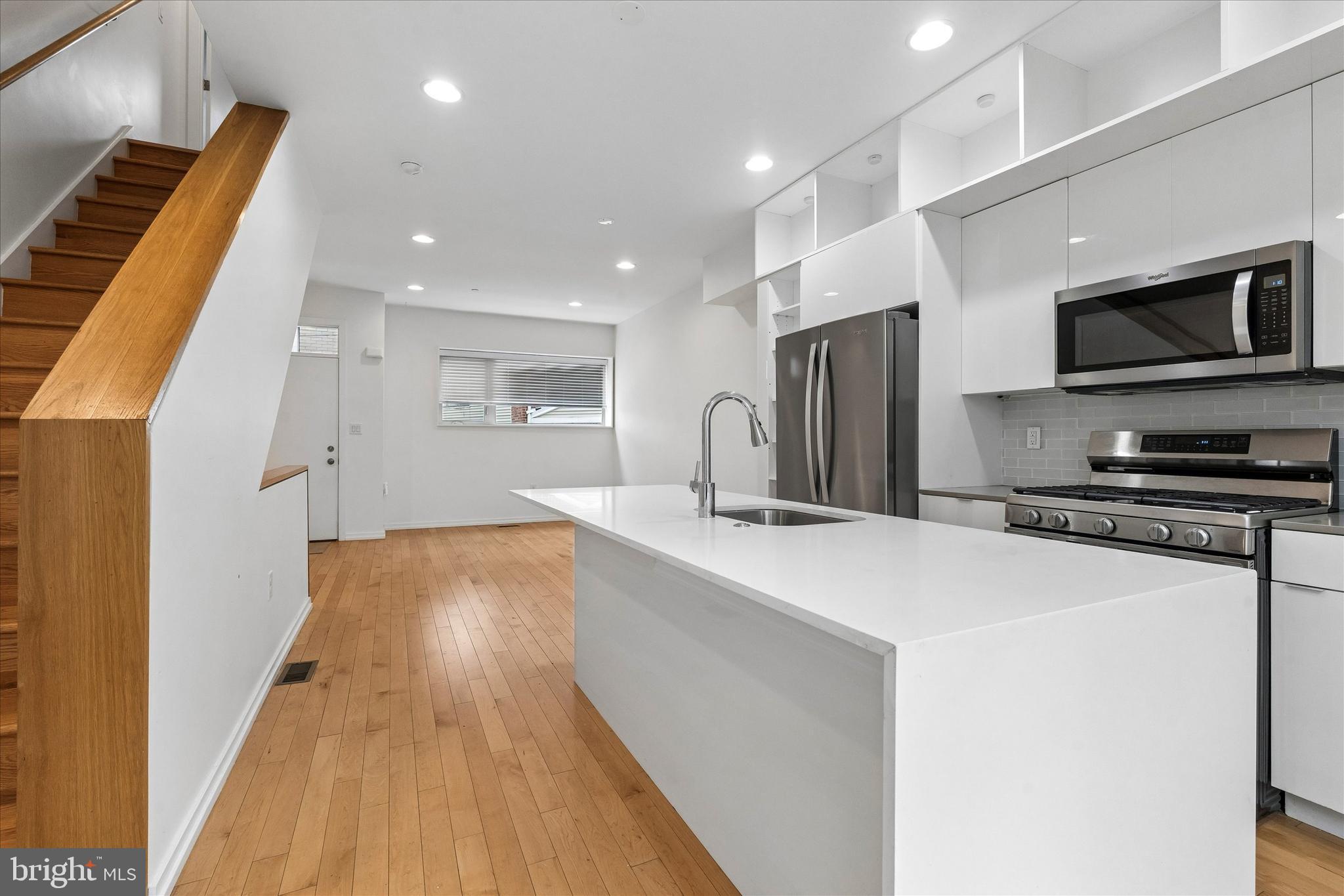 936 North Leithgow Street Philadelphia, PA 19123 - Photo 2 of 40 a kitchen with stainless steel appliances a refrigerator and a stove top oven