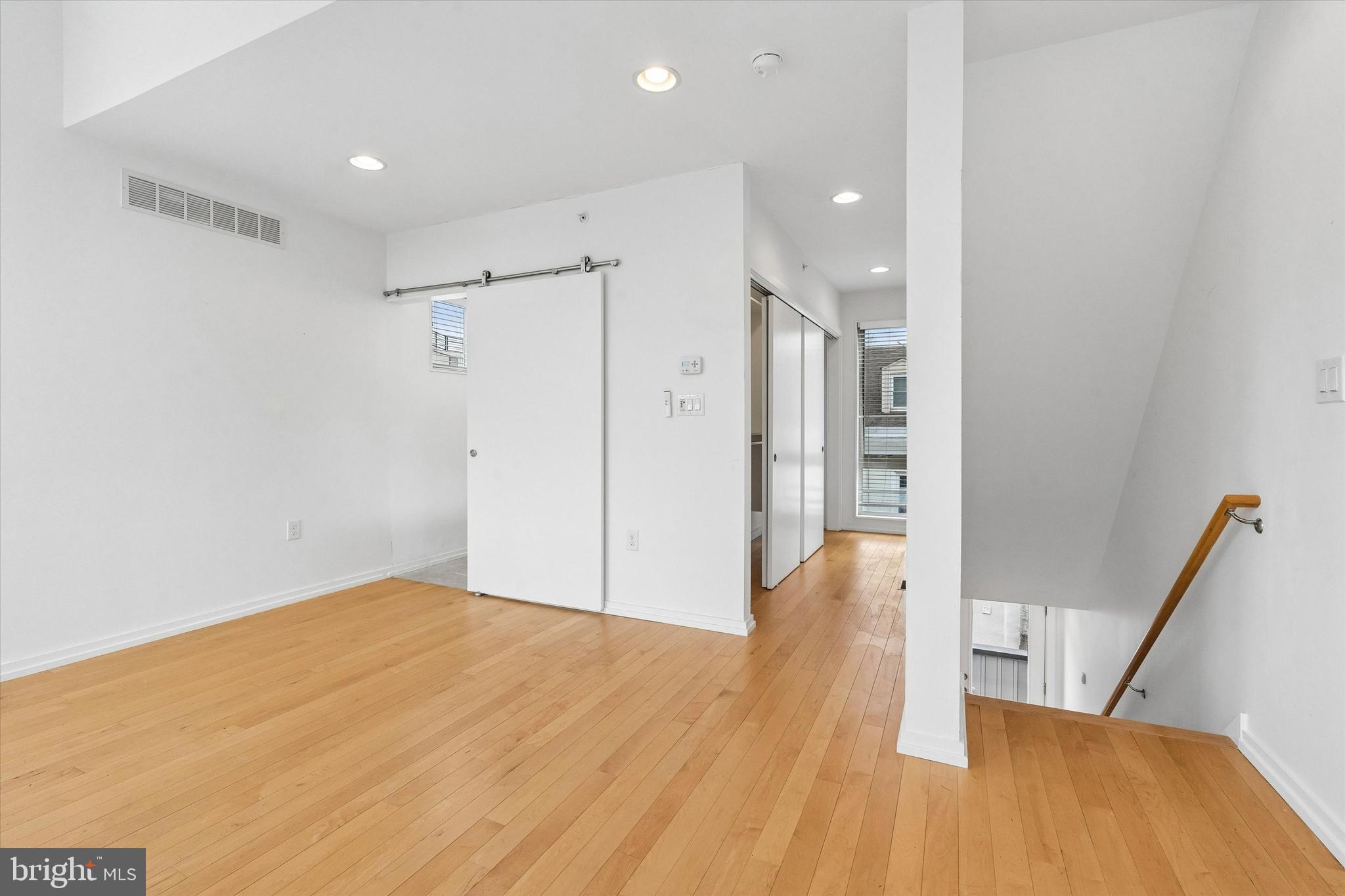 936 North Leithgow Street Philadelphia, PA 19123 - Photo 23 of 40 a view of empty room with wooden floor and stairs