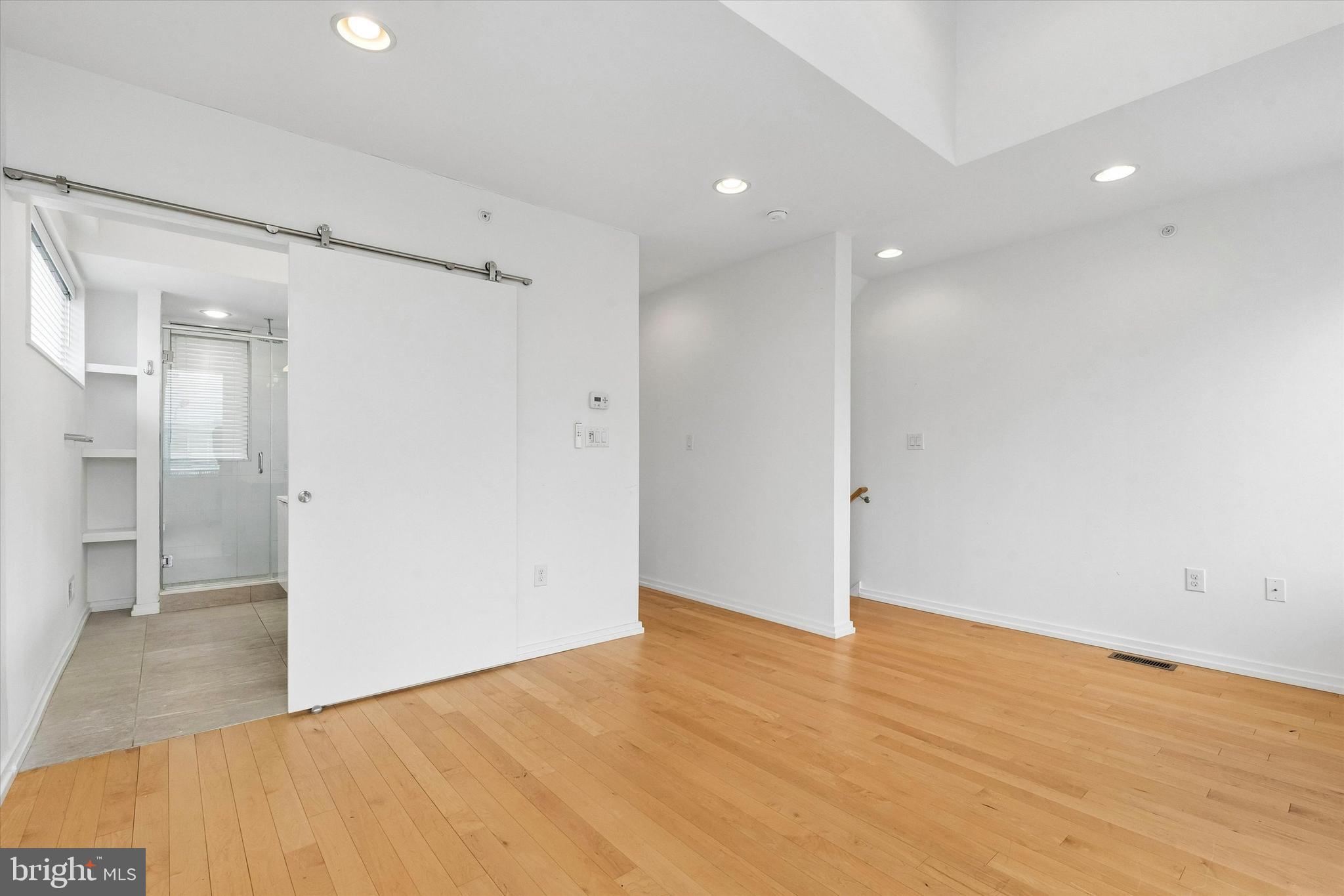 936 North Leithgow Street Philadelphia, PA 19123 - Photo 24 of 40 an empty room with wooden floor and windows