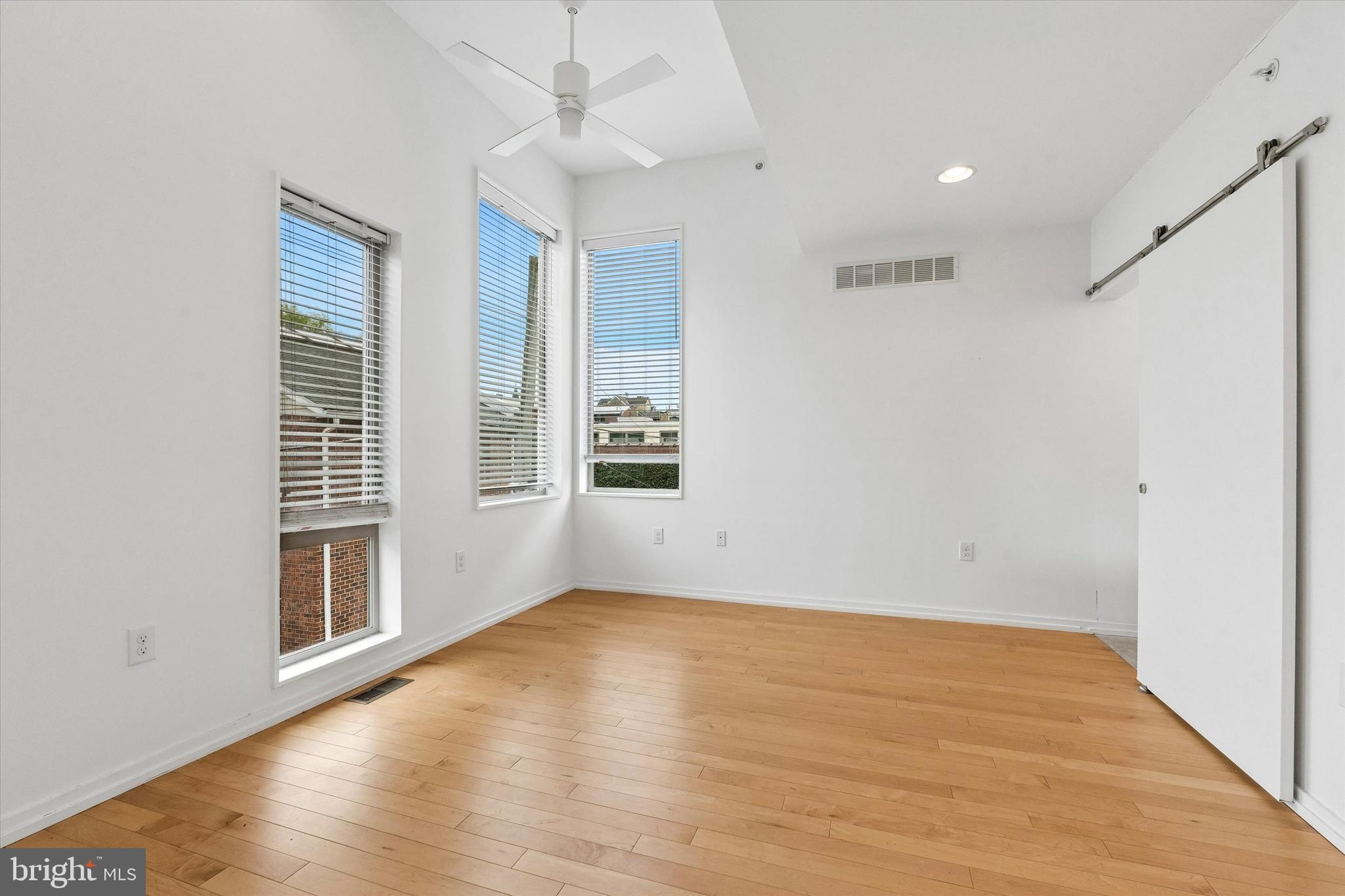 936 North Leithgow Street Philadelphia, PA 19123 - Photo 25 of 40 a view of an empty room with wooden floor and a window