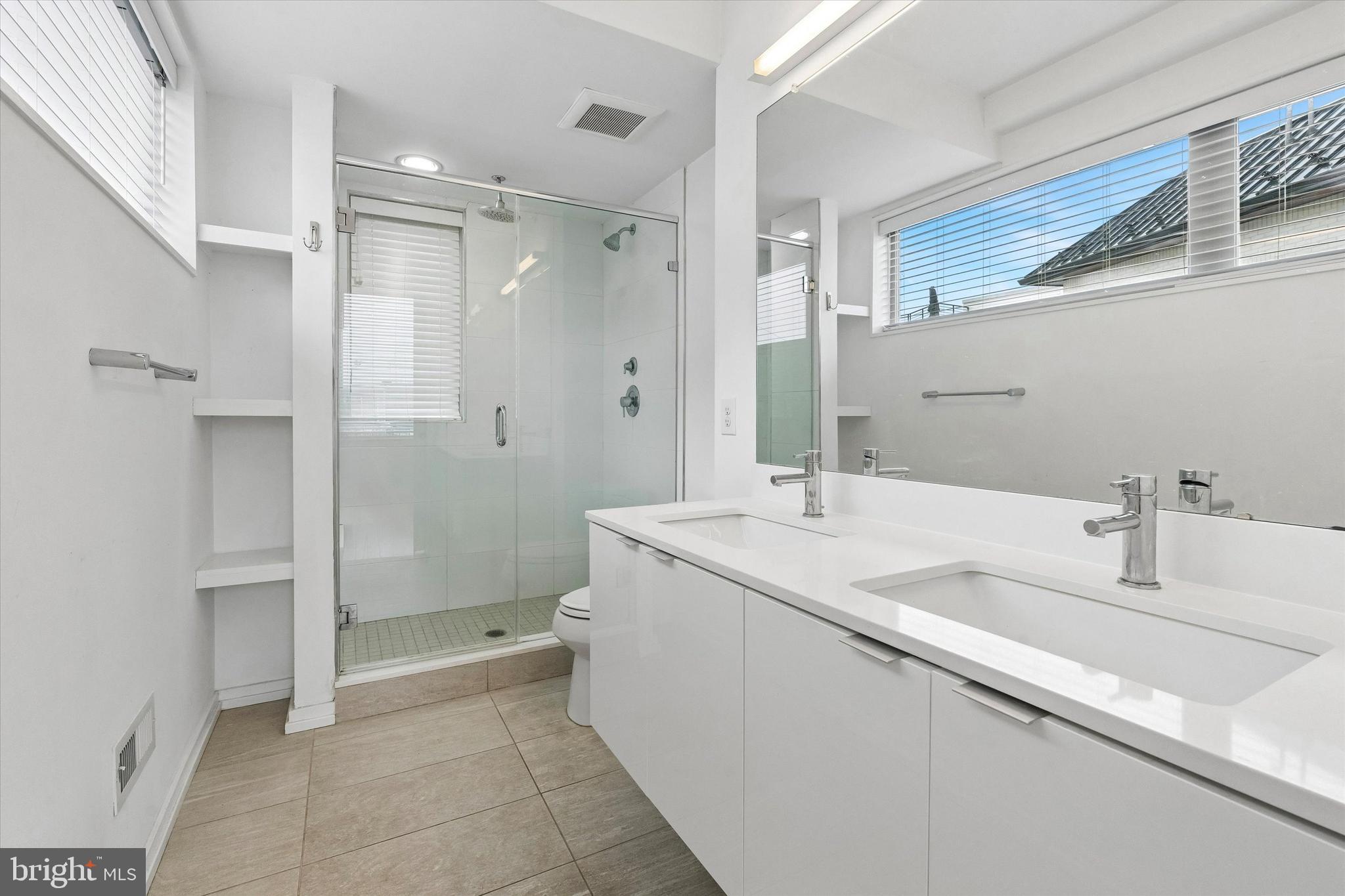 936 North Leithgow Street Philadelphia, PA 19123 - Photo 26 of 40 a bathroom with a shower sink and mirror