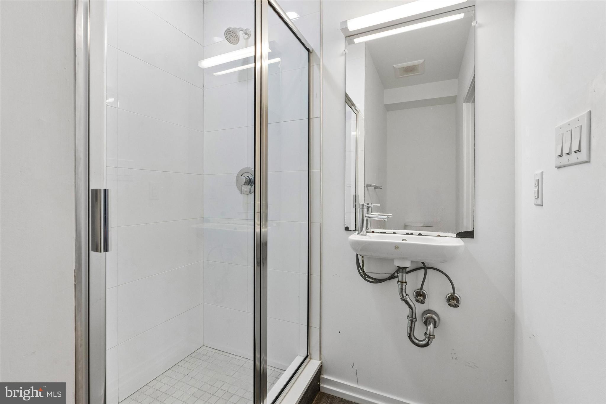 936 North Leithgow Street Philadelphia, PA 19123 - Photo 35 of 40 a bathroom with a glass shower door