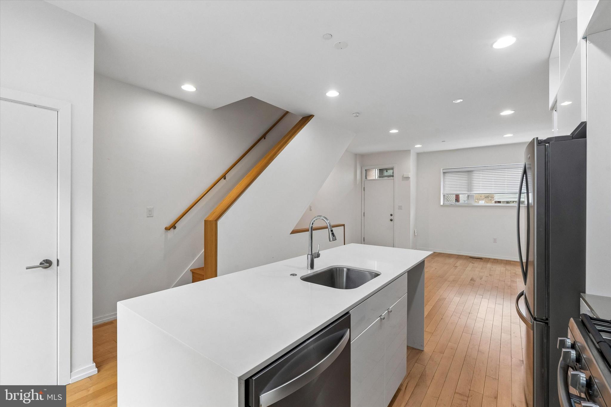 936 North Leithgow Street Philadelphia, PA 19123 - Photo 5 of 40 a kitchen with a sink a refrigerator and wooden floor