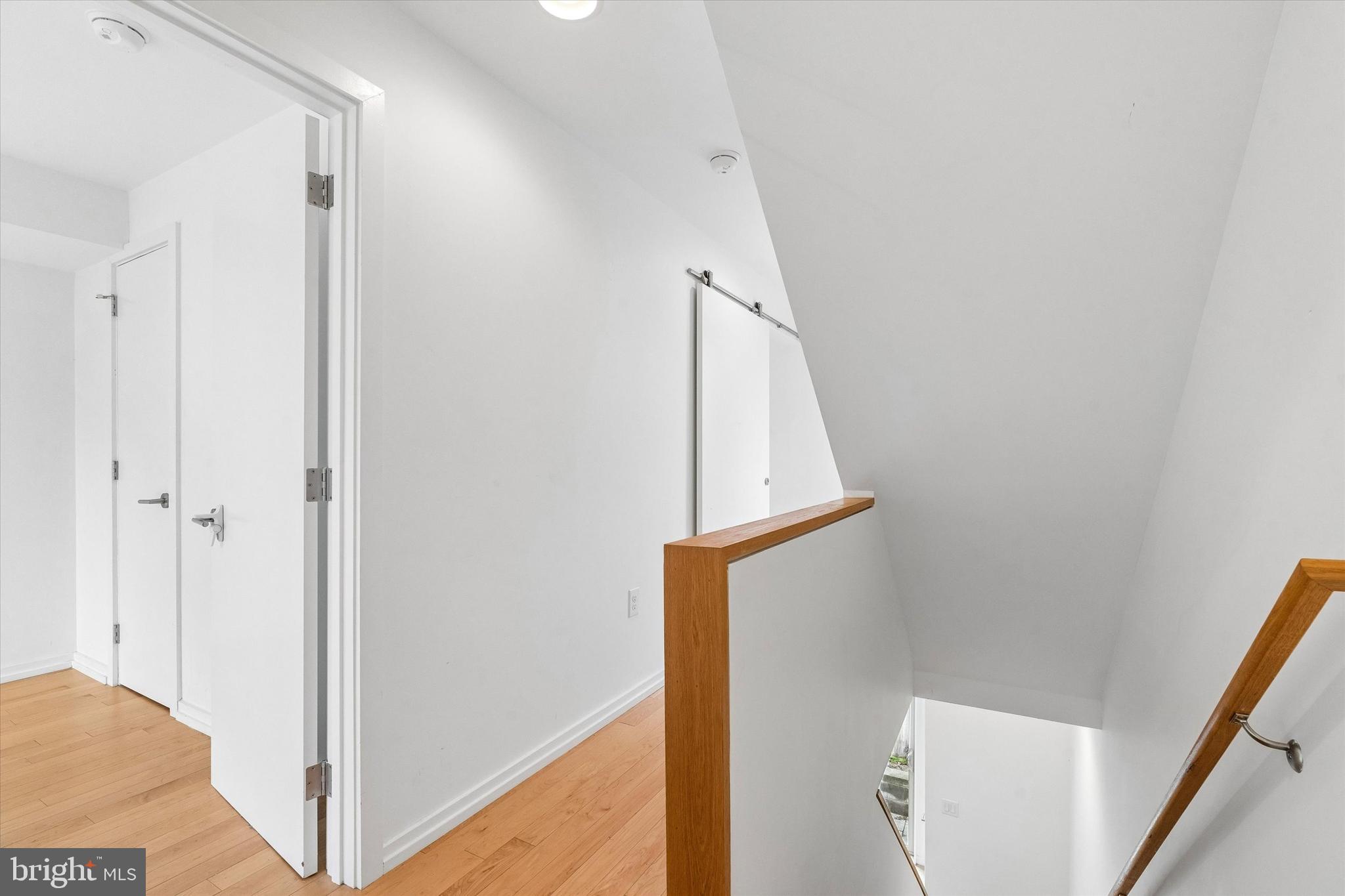 936 North Leithgow Street Philadelphia, PA 19123 - Photo 8 of 40 a view of a hallway with wooden floor and staircase