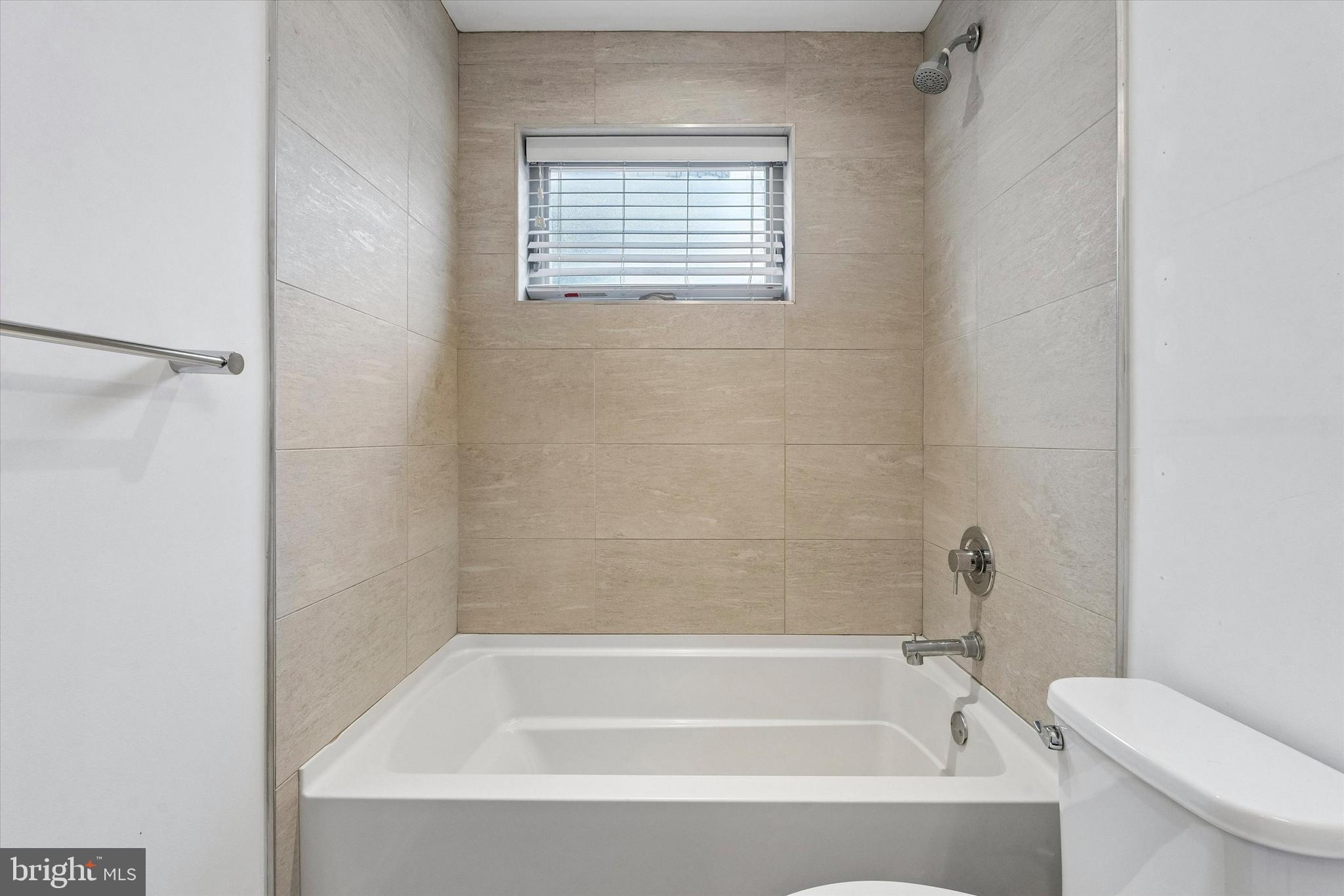 936 North Leithgow Street Philadelphia, PA 19123 - Photo 10 of 40 a white bath tub sitting next to a white toilet