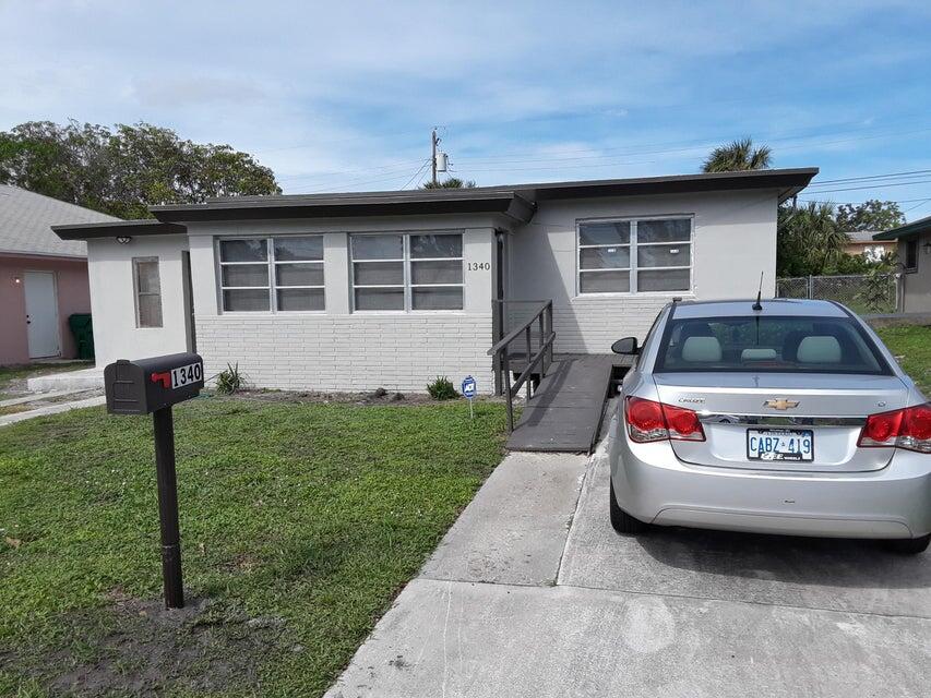 1340 West 33rd Street Riviera Beach, FL 33404 - Photo 1 of 11 a car parked in front of a house