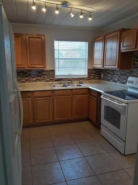 1340 West 33rd Street Riviera Beach, FL 33404 - Photo 3 of 11 a kitchen with stainless steel appliances granite countertop a stove sink and cabinets