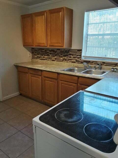 1340 West 33rd Street Riviera Beach, FL 33404 - Photo 4 of 11 a kitchen with a sink and a stove