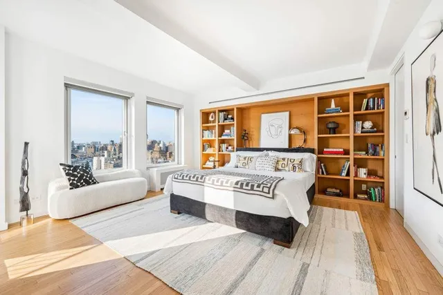 a kitchen with stainless steel appliances a stove a white cabinet and a granite countertops with wooden floor