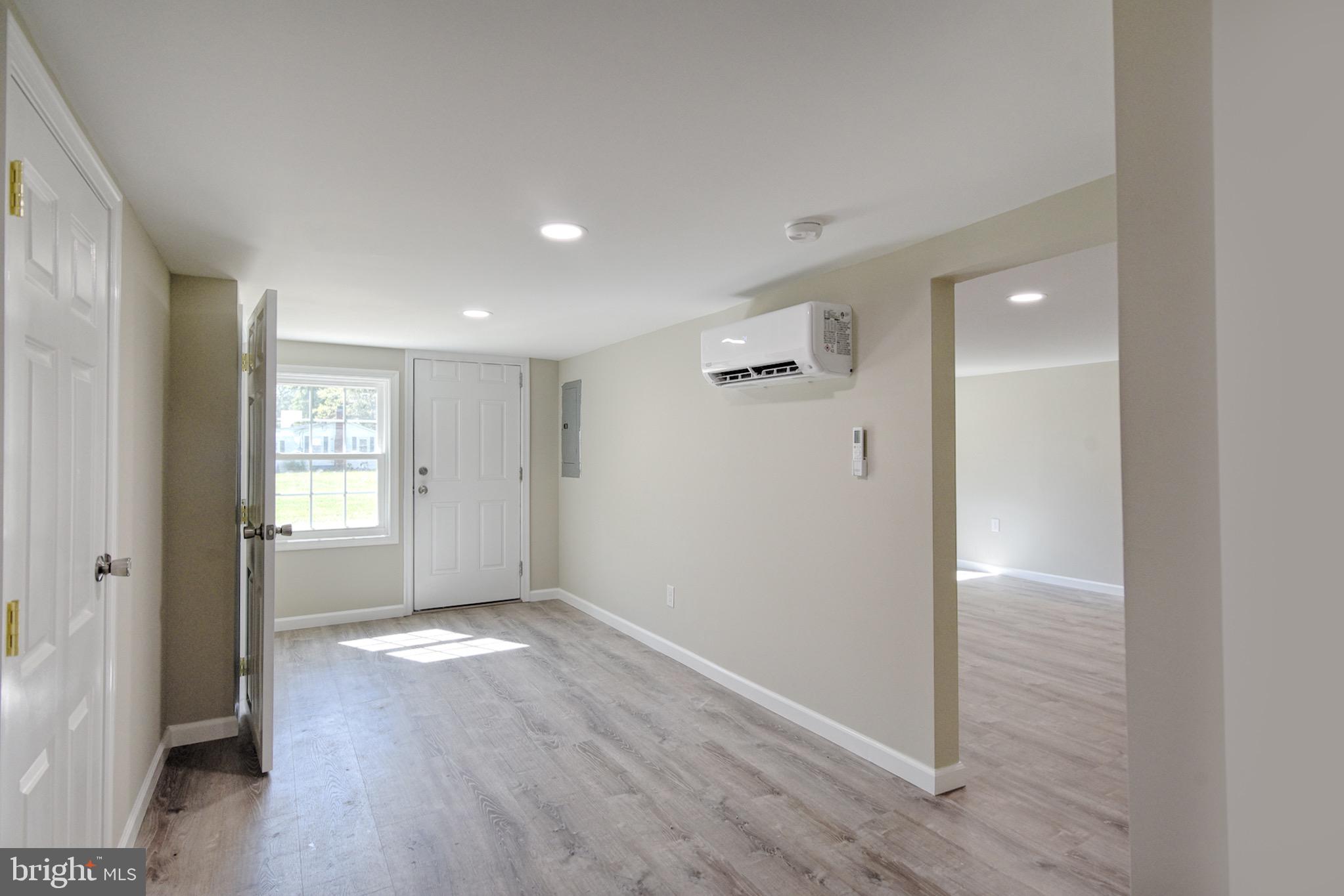 8833 Georgetown Road Chestertown, MD 21620 - Photo 12 of 47 an empty room with wooden floor and windows