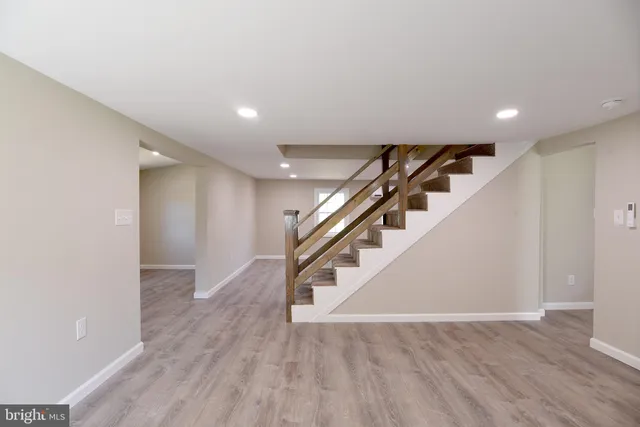 a view of entryway and hall with wooden floor