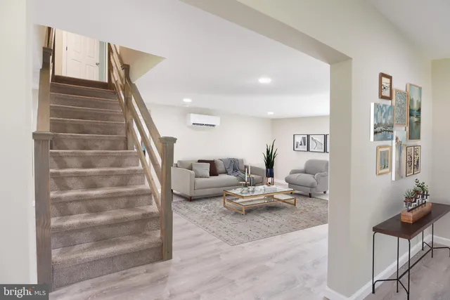 a living room with furniture and stairs