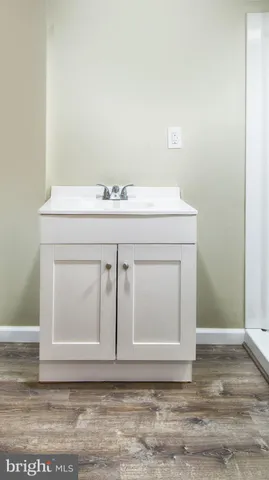 a bathroom with a sink vanity and granite