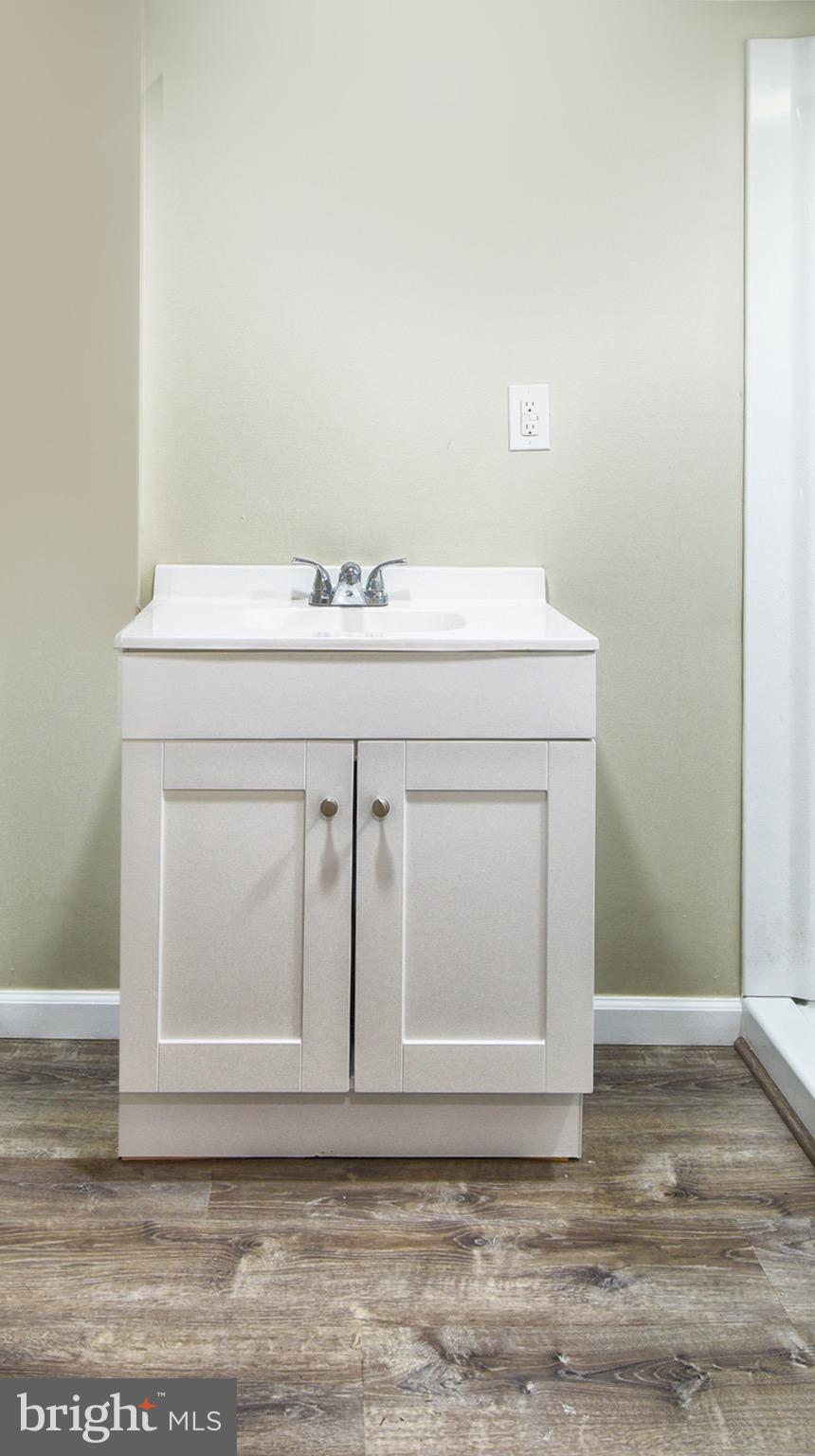 8833 Georgetown Road Chestertown, MD 21620 - Photo 25 of 47 a bathroom with a sink vanity and granite