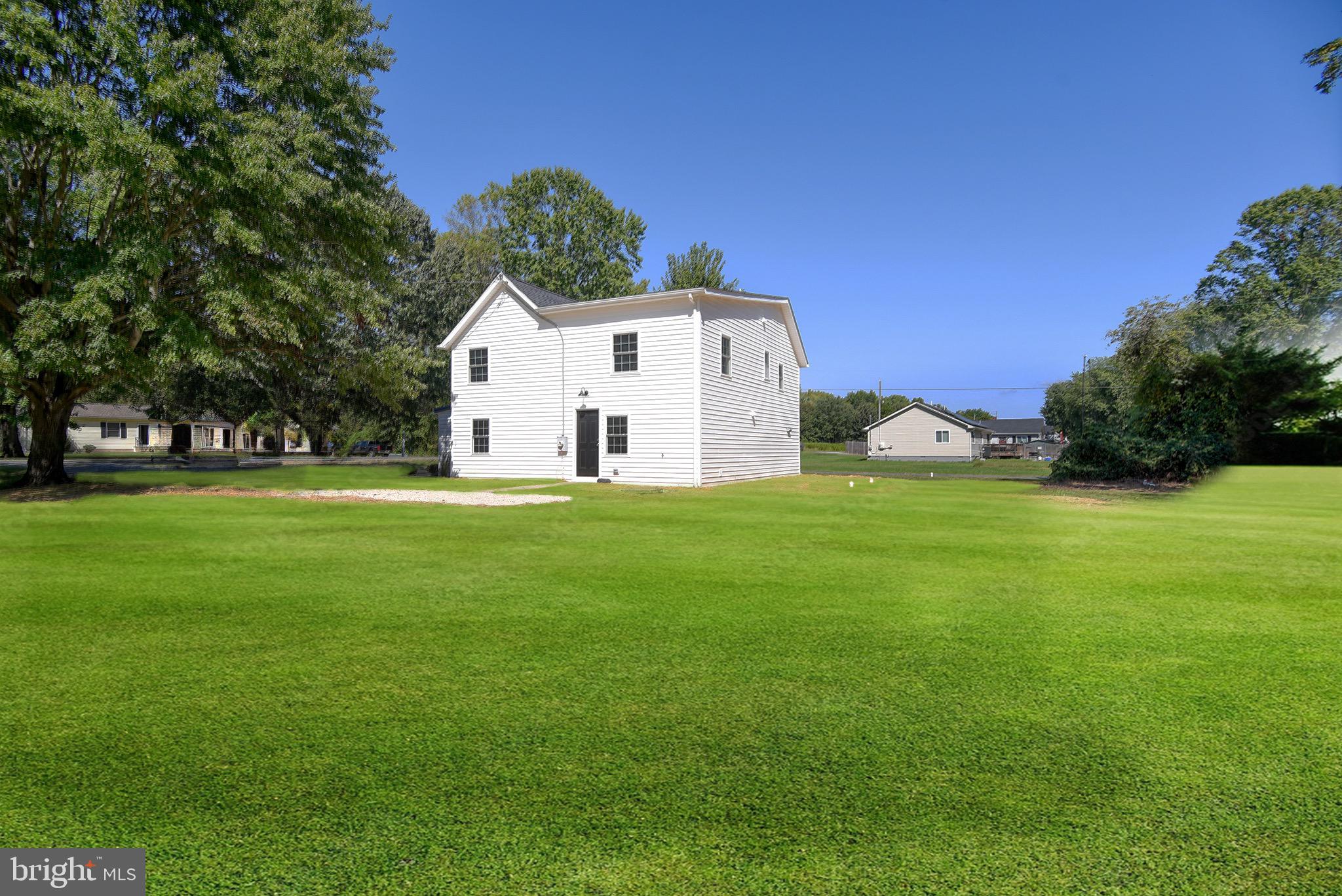8833 Georgetown Road Chestertown, MD 21620 - Photo 32 of 47 a white house with a big yard and large trees