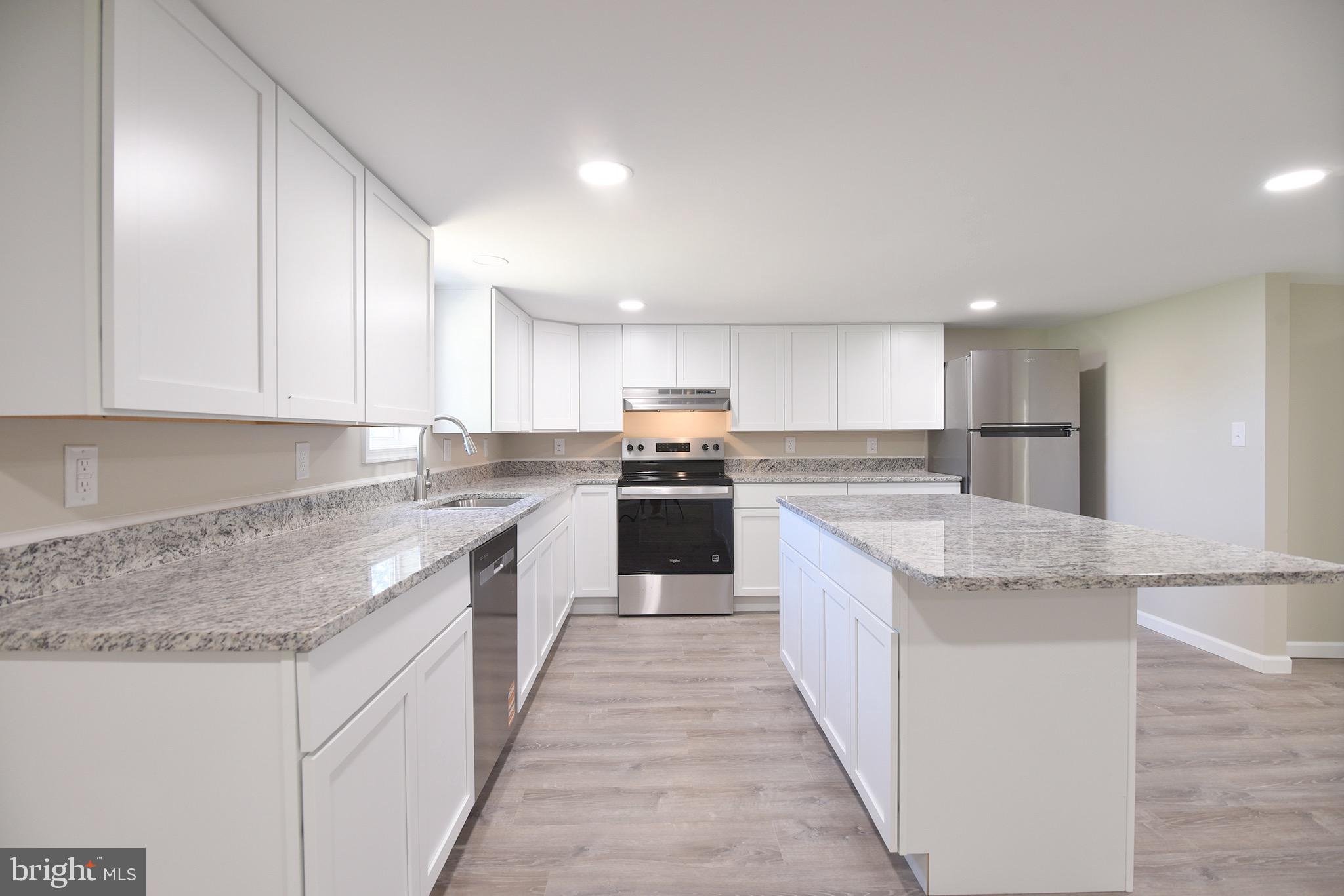 8833 Georgetown Road Chestertown, MD 21620 - Photo 4 of 47 a large kitchen with granite countertop lots of counter top space and cabinets