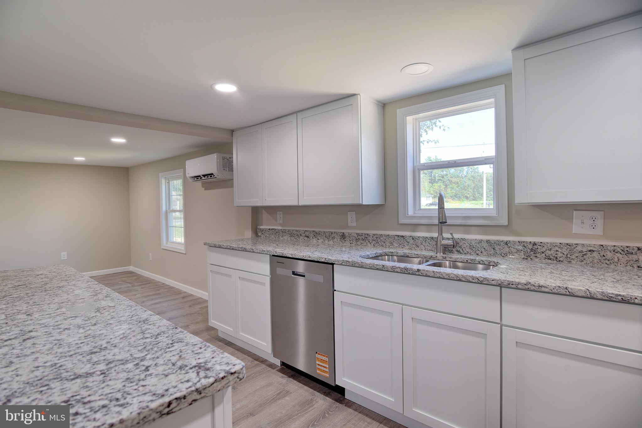 8833 Georgetown Road Chestertown, MD 21620 - Photo 5 of 47 a kitchen with white cabinets granite counter tops and a window