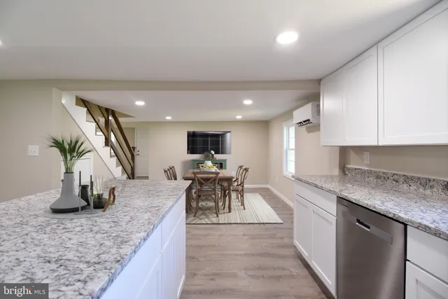 a kitchen with sink a counter and chairs