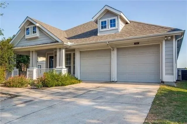 a view of house with garage and yard