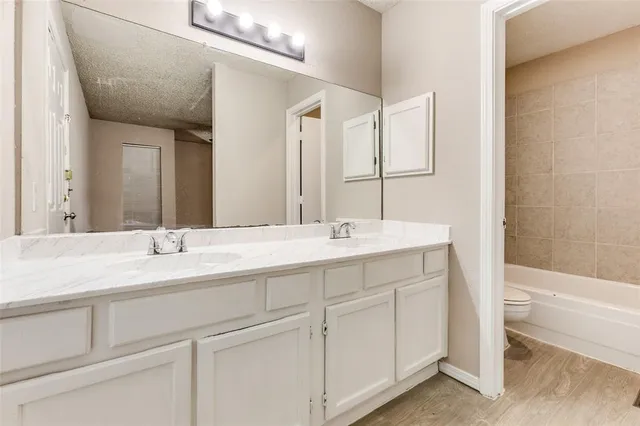 a bathroom with a toilet a sink and a bathtub