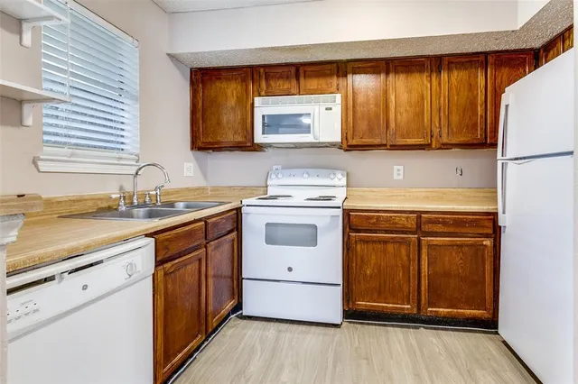 a kitchen with a white cabinets and white appliances