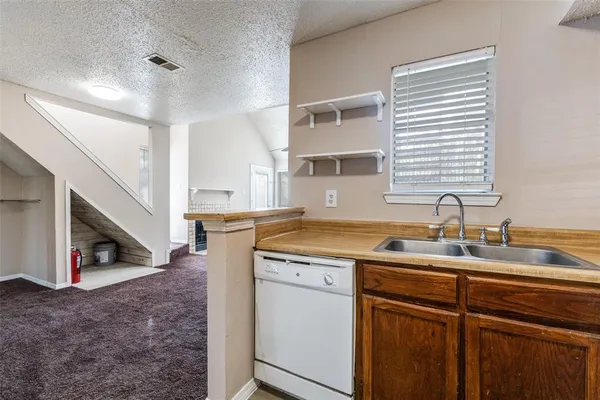 a kitchen with sink and cabinets