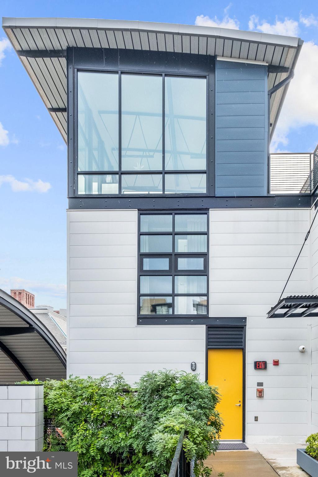 a view of a house with a window and potted plants