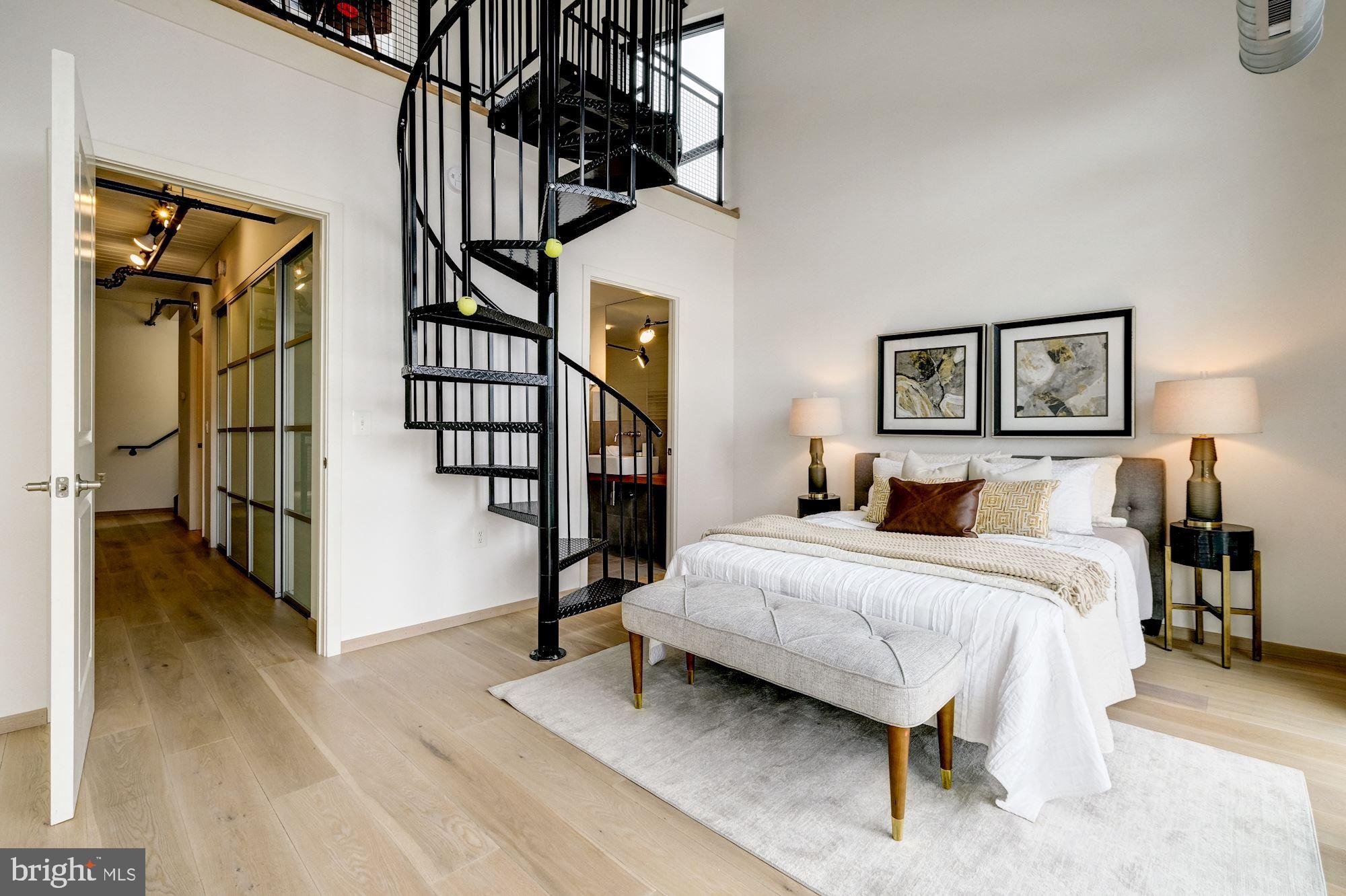 2125 14th Street Northwest, Unit 315W Washington, DC 20009 - Photo 16 of 35 a bedroom with a bed and a chandelier