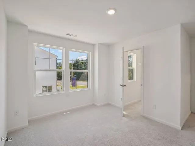a living room with furniture and a mirror