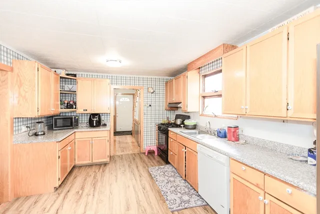 a kitchen with stainless steel appliances a sink stove and cabinets