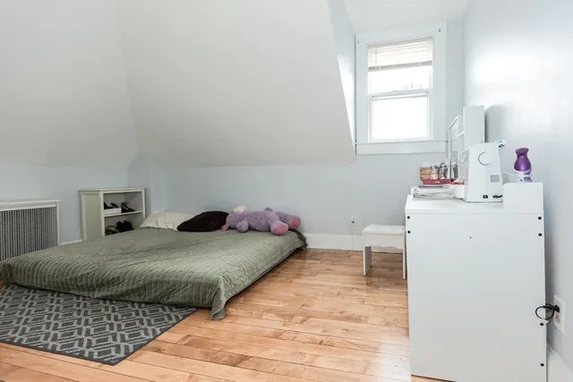 a bedroom with a bed and window