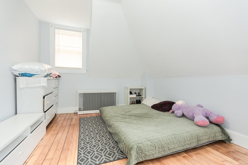68 Spring Street Holbrook, MA 02343 - Photo 16 of 21 a bedroom with a bed and wooden floor