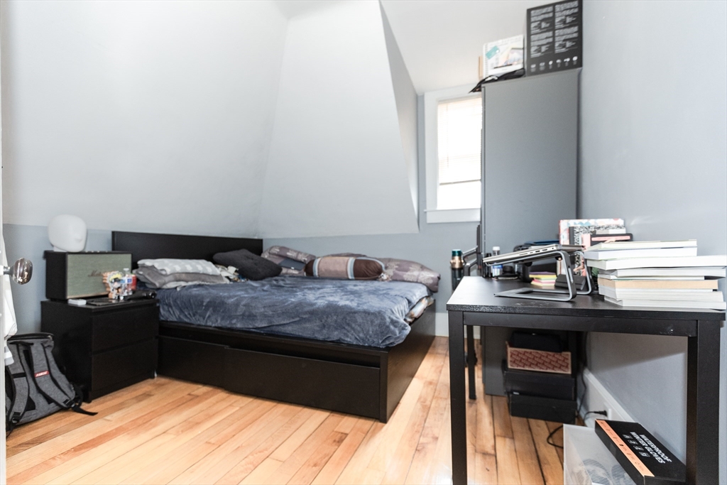 68 Spring Street Holbrook, MA 02343 - Photo 17 of 21 a bedroom with a bed and a table in it