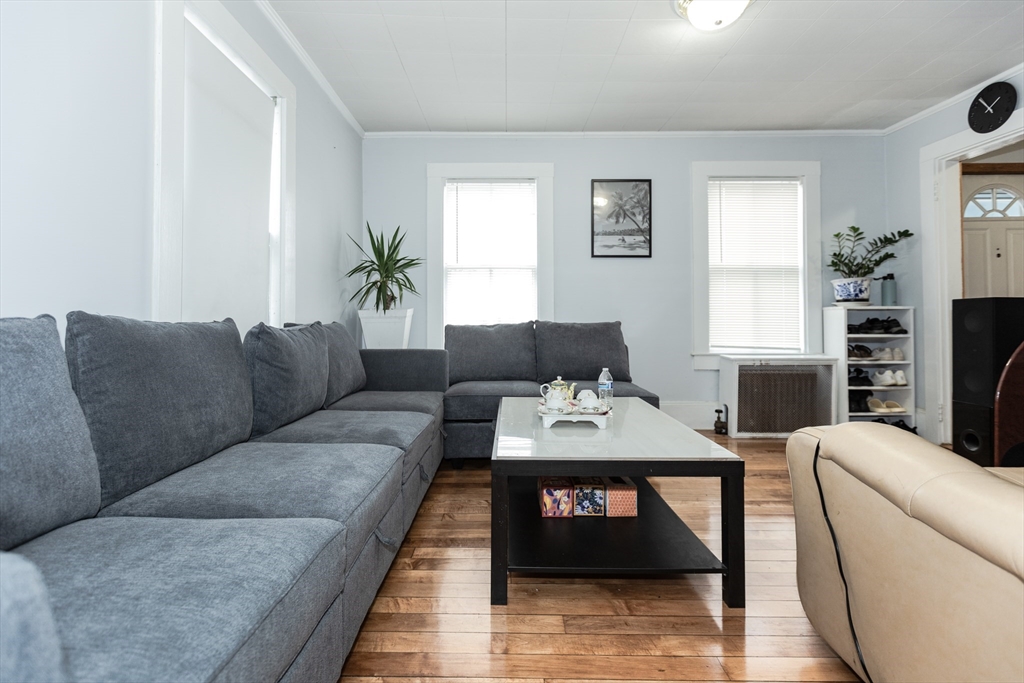 68 Spring Street Holbrook, MA 02343 - Photo 3 of 21 a living room with furniture a table and a potted plant