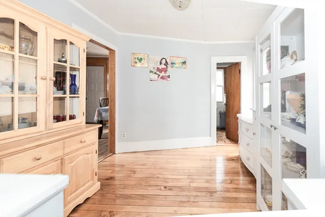 a view of a kitchen with an entryway and wooden floor