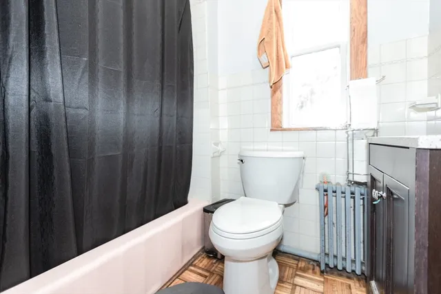 a bathroom with a toilet a sink and a window