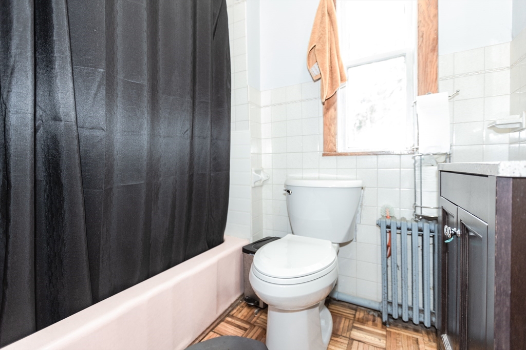 68 Spring Street Holbrook, MA 02343 - Photo 8 of 21 a bathroom with a toilet a sink and a window