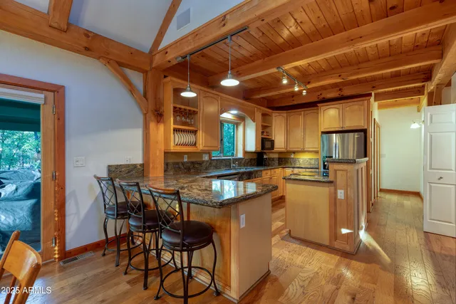 a view of a dining room with furniture a chandelier and wooden floor