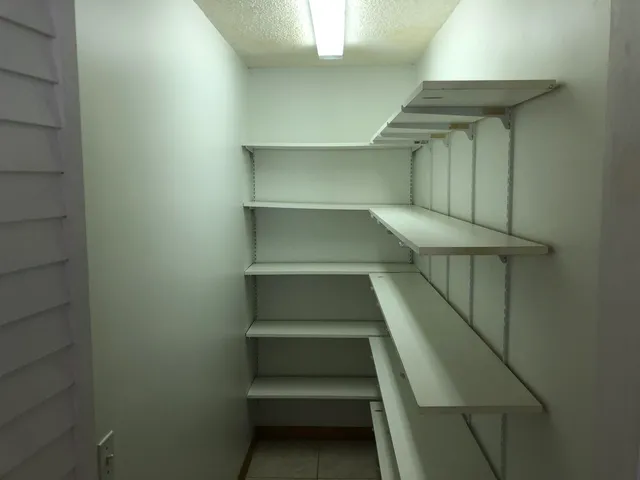 an empty room with windows and outdoor view