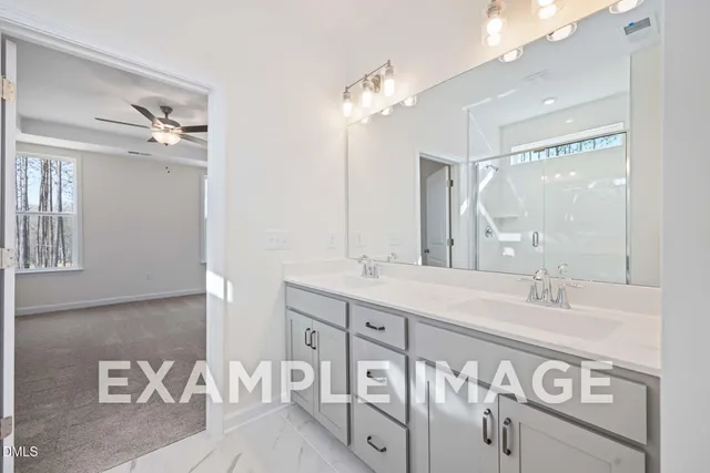 a bathroom with a double vanity sink and a mirror