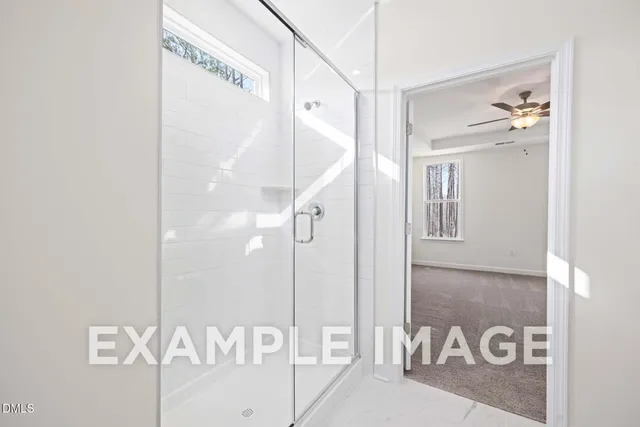 a view of a hallway with wooden floor and glass door