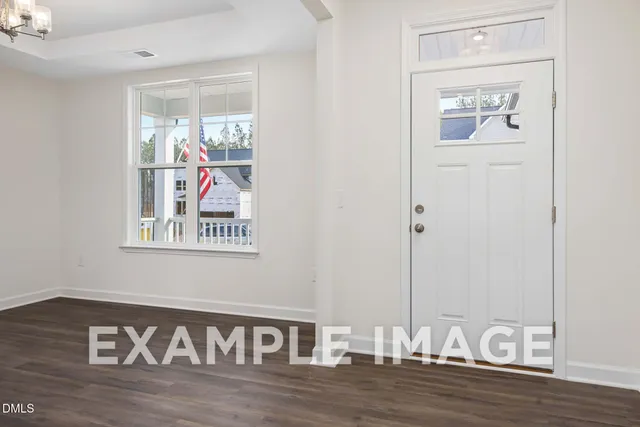 a view of a hallway with wooden floor and dining room