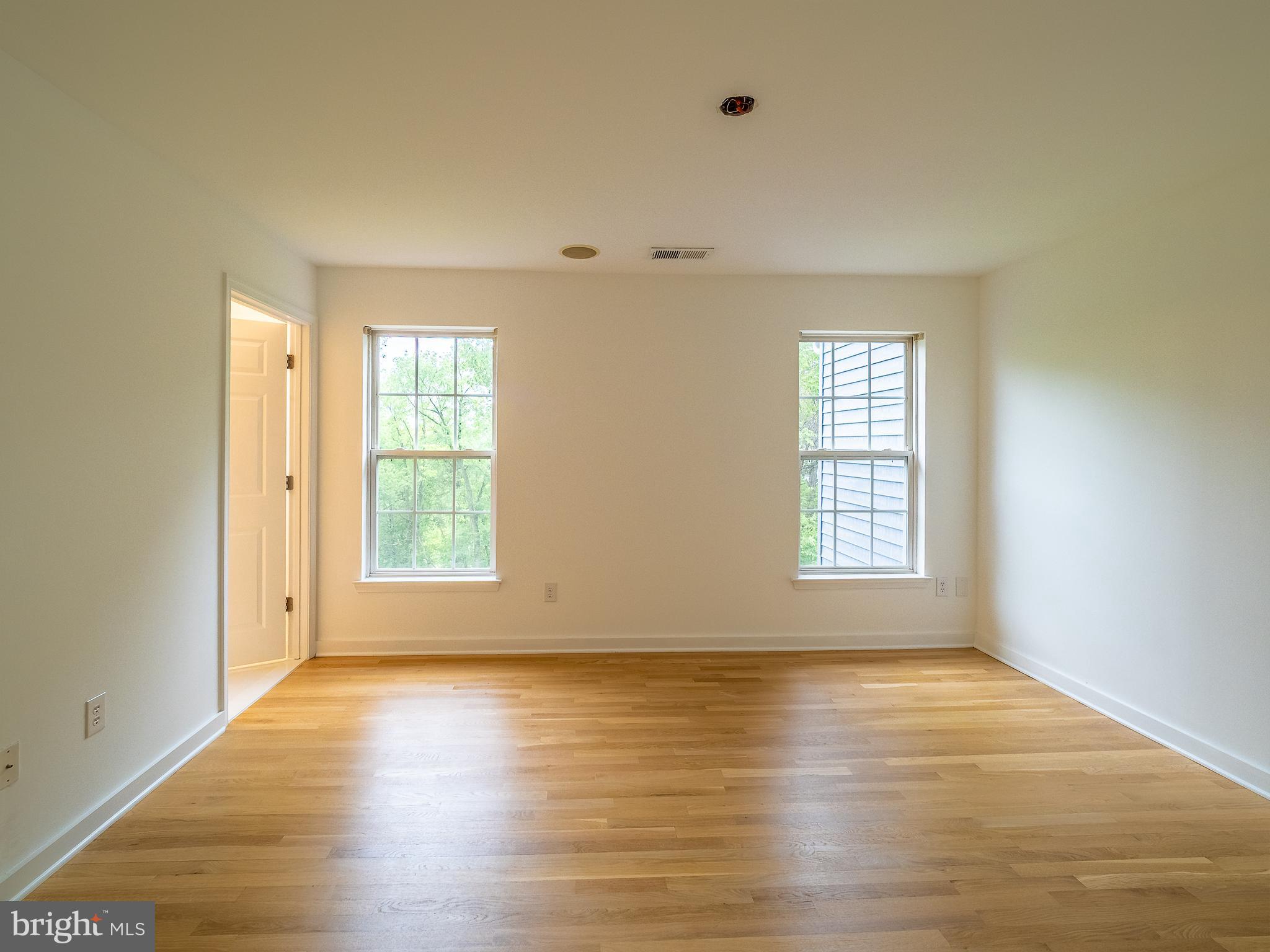 70 River Lane Delanco, NJ 08075 - Photo 18 of 35 an empty room with wooden floor and windows