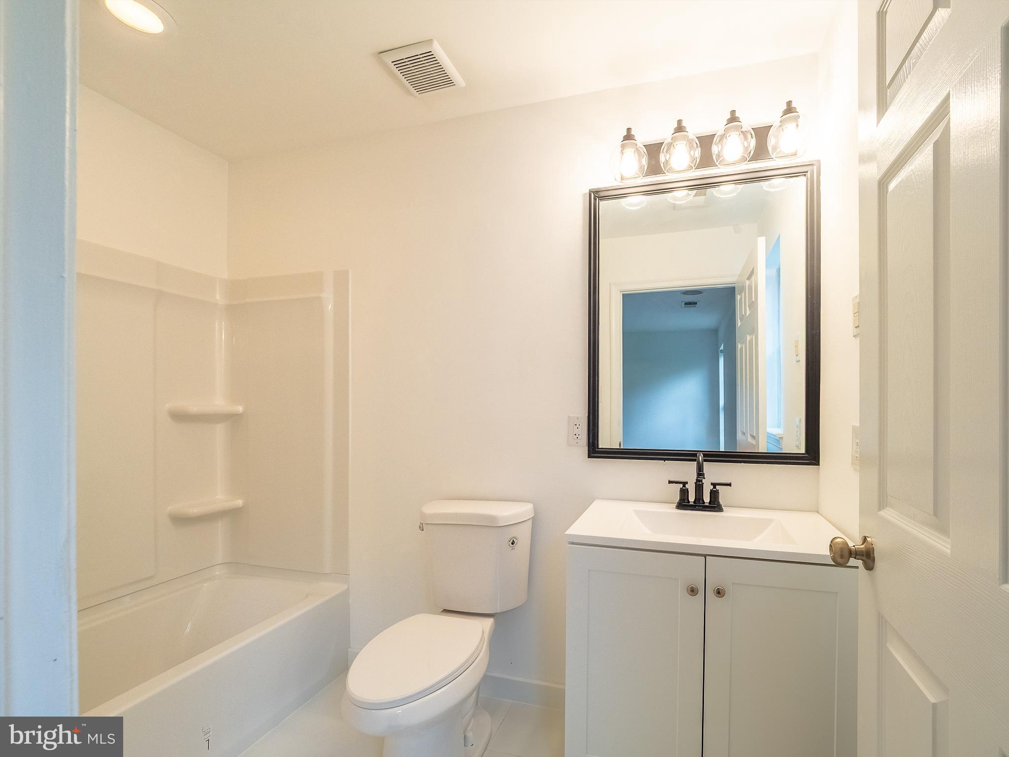 70 River Lane Delanco, NJ 08075 - Photo 21 of 35 a bathroom with a sink a toilet and shower