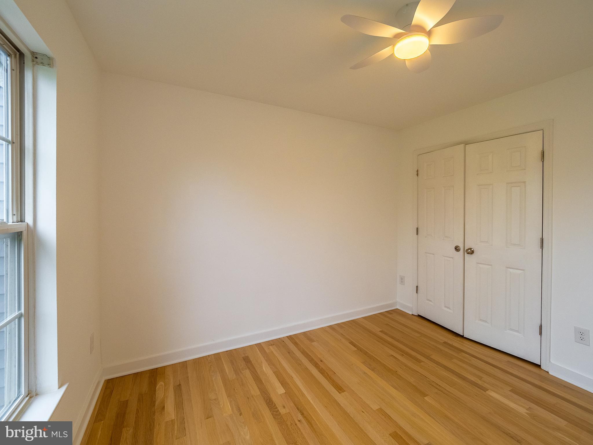 70 River Lane Delanco, NJ 08075 - Photo 22 of 35 a view of empty room with wooden floor and fan