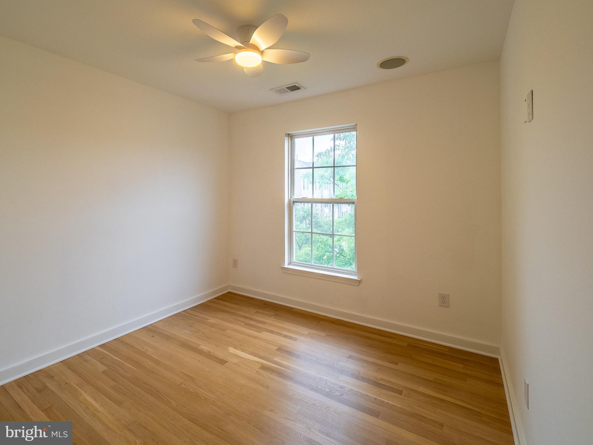 70 River Lane Delanco, NJ 08075 - Photo 23 of 35 an empty room with wooden floor and windows