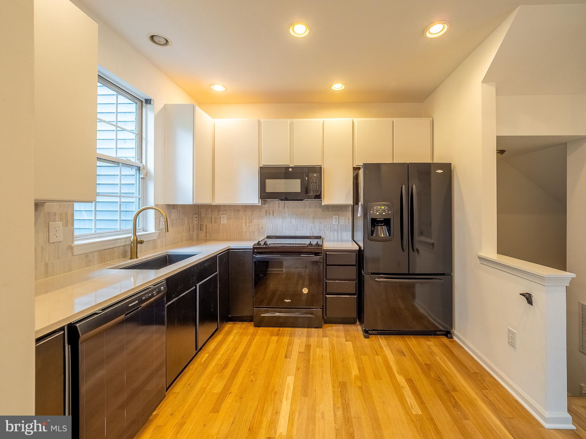 70 River Lane Delanco, NJ 08075 - Photo 5 of 35 a kitchen with granite countertop a refrigerator and a sink