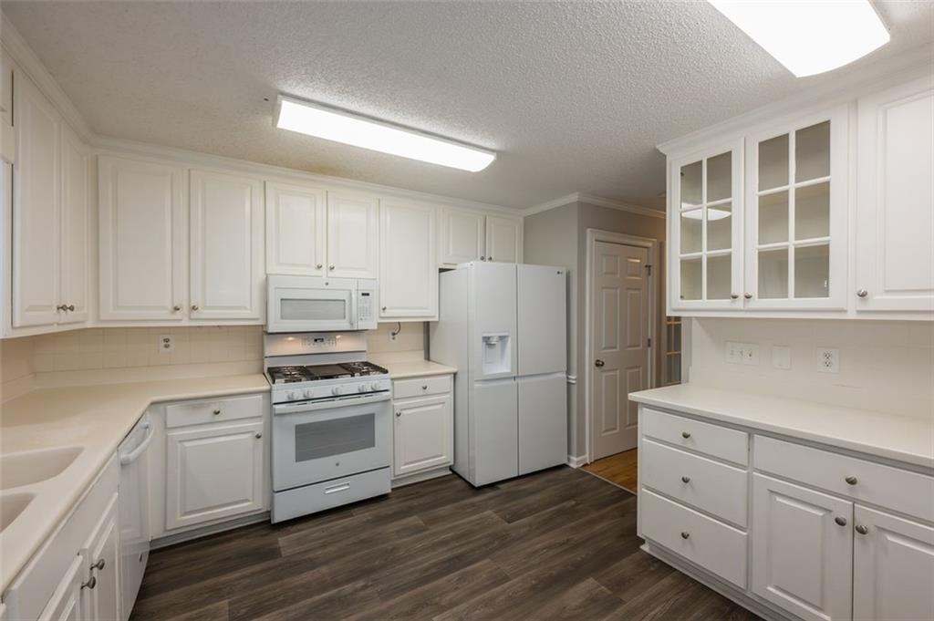 4648 Calumet Circle Northwest Duluth, GA 30096 - Photo 12 of 37 a kitchen with cabinets appliances wooden floor and a window