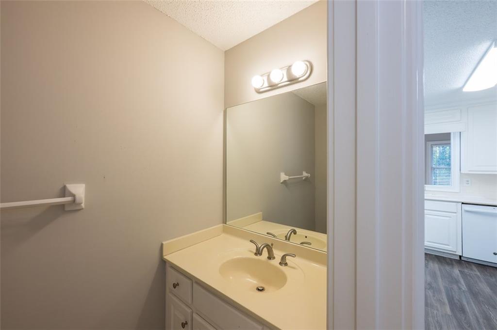 4648 Calumet Circle Northwest Duluth, GA 30096 - Photo 16 of 37 a bathroom with a sink a vanity and a mirror